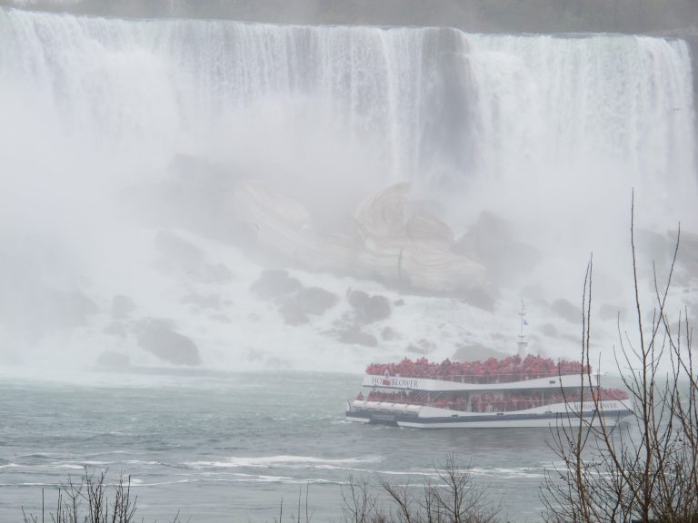 In this May 15, 2014 photo, a Hornblower Niagara Cruises catamaran carries passengers past the American Falls. San Francisco-based Hornblower Co. launched its Niagara Falls cruises from the Canadian shoreline in May after winning the rights in 2012. The Maid of the Mist Steamboat Co. continues to launch from the American shore but lost its Canadian contract to rival Hornblower Niagara Cruises.(AP Photo/Carolyn Thompson)