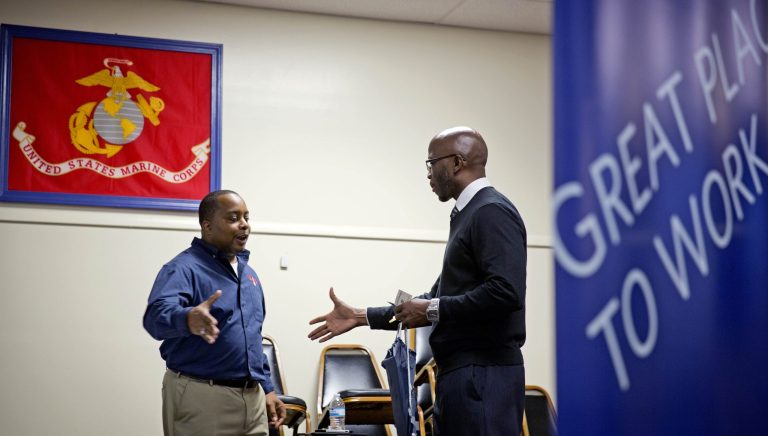 FILE - In this  Thursday, Nov. 14, 2013, file photo, retired U.S. Army Sgt. 1st Class Duane Stubbs, right, of Morrow, Ga., shakes hands with retired U.S. Army 1st Sgt. Leland Smith, CEO of SolidHires, during a job fair for veterans at the VFW Post 2681, in Marietta, Ga. The Labor Department reports on the number of Americans who applied for unemployment benefits last week on Wednesday, Nov. 27, 2013. (AP Photo/David Goldman, File)