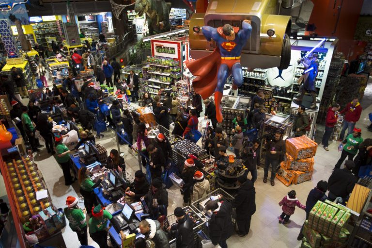 Customers wait in line at the flagship Toys 'R' Us store in New York's Times Square. The bankrupt retailer is closing all its U.S. stores.
