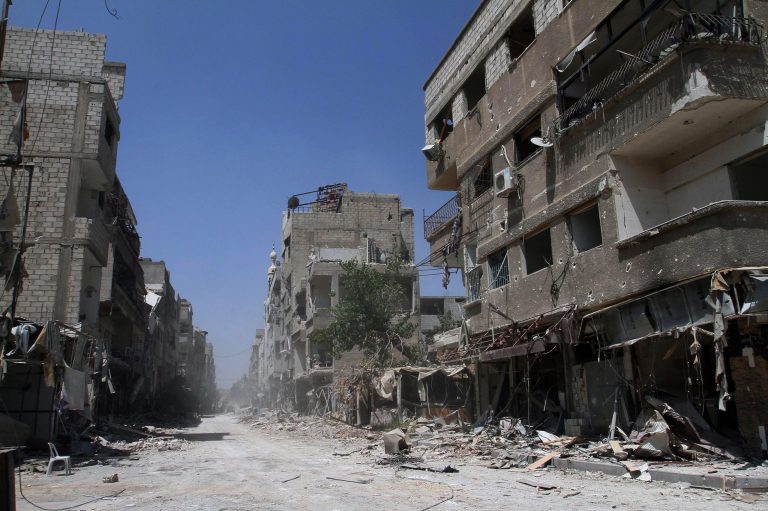 In this photo taken during a Syrian government-led media tour, buildings damaged during battles between Syrian troops and rebels stand along an empty street in Mleiha, some 10 kilometers (6 miles) southeast of downtown Damascus, Syria, Friday, Aug. 15, 2014. Syrian government troops captured the fiercely contested suburb of the capital Thursday after five months of heavy fighting, flushing rebels from their last hideouts and quickly moving to crush pockets of resistance in the surrounding countryside, activists and state media said. (AP Photo)