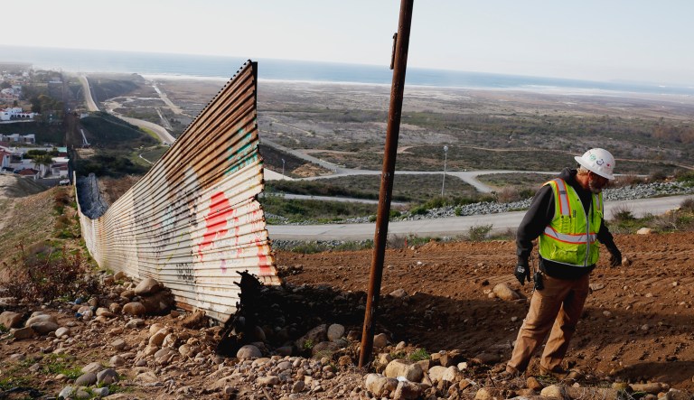 Stewart Williams works with a crew removing border-related construction to replace it with a new border wall on Wednesday, Jan. 9, 2019, as seen from Tijuana, Mexico.