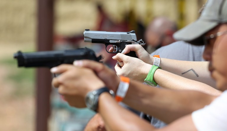In this July 20, 2014 photo, shooters practice with pistols at the gun range at Dragonman's, a gun dealer east of Colorado Springs, Colo.