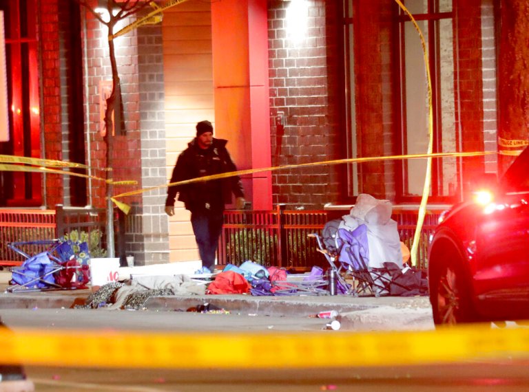 Police investigate at the scene of a crash involving multiple people and injuries at a holiday parade in Waukesha on Sunday, Nov. 21, 2021.