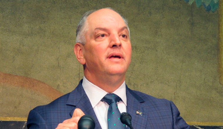 Gov. John Bel Edwards talks about an expected $300 million-plus surplus Louisiana will have from the last budget year, while Commissioner of Administration Jay Dardenne and Revenue Secretary Kimberly Robinson listen to his remarks, on Thursday, Sept. 20, 2018, in Baton Rouge, La.