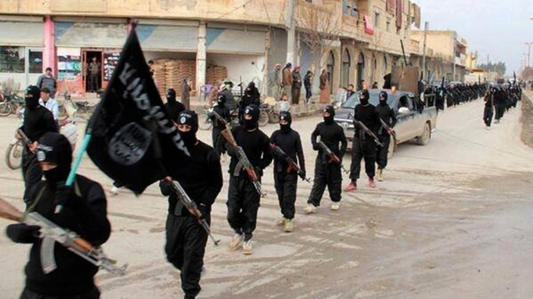 This undated file image posted on a militant website on Tuesday, Jan. 14, 2014, which has been verified and is consistent with other AP reporting, shows fighters from the al-Qaida linked Islamic State of Iraq and the Levant (ISIL), now called the Islamic State group, marching in Raqqa, Syria. (Militant Website via AP, File)