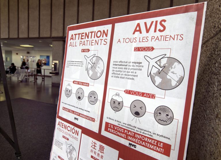 A sign advising advising those who are showing possible Ebola symptoms is posted in a lobby of New York's Bellevue Hospital, Wednesday. (AP/Richard Drew)