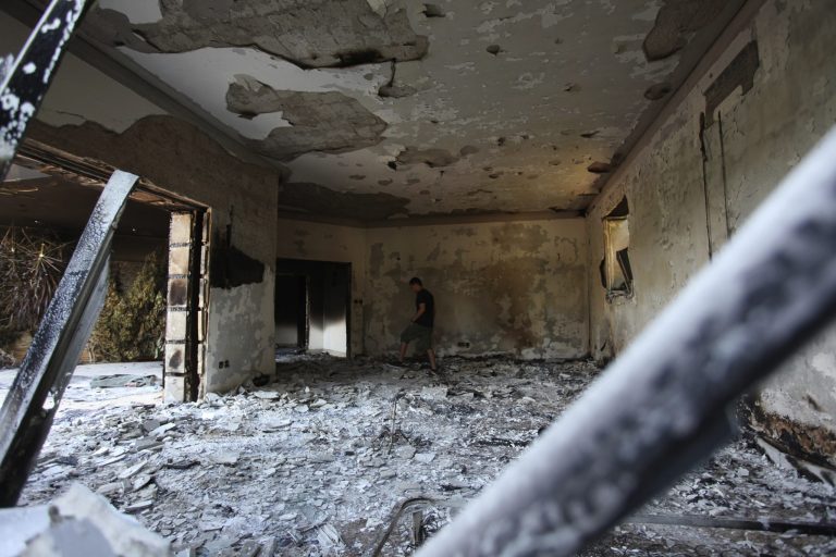 A Libyan man walks in the rubble of the damaged U.S. consulate in Benghazi, Libya, on Sept. 13, 2012. (AP Photo/Mohammad Hannon)