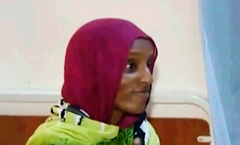 In this Image made from an undated video provided Thursday, June 5, 2014, by Al Fajer, a Sudanese nongovernmental organization, Meriam Ibrahim is visited by the NGO at a prison in Khartoum, Sudan. (AP Photo/Al Fajer)