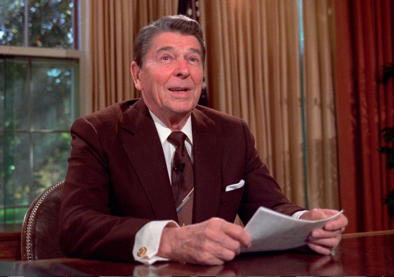President Ronald Reagan works at his desk in the Oval Office of the White House as he prepares a speech on tax revision in this May 24,1985 photo. (AP Photo/Scott Stewart)