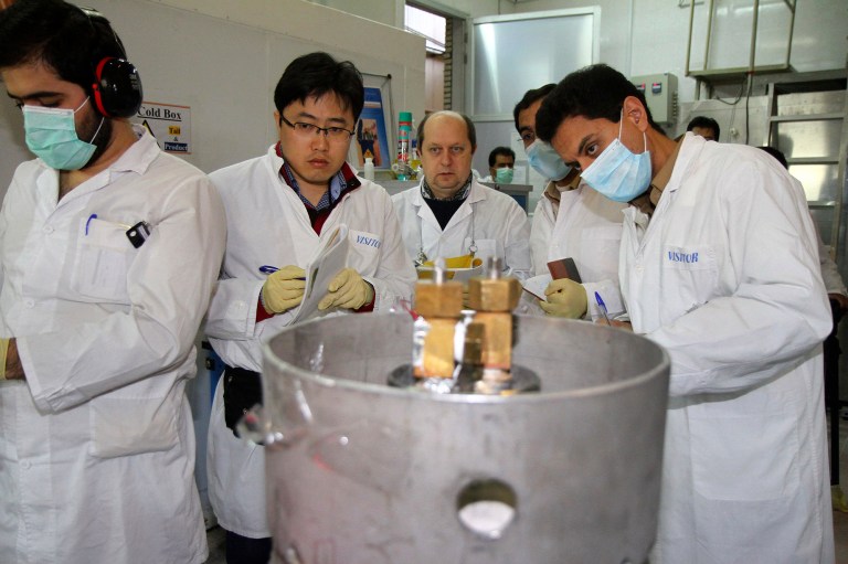 Unidentified International Atomic Energy Agency (IAEA) inspectors and Iranian technicians are on hand to cut the connections between the twin cascades for 20 percent uranium enrichment at Natanz facility, some 200 miles (322 kilometers) south of the capital Tehran, Iran, Monday, Jan. 20, 2014.