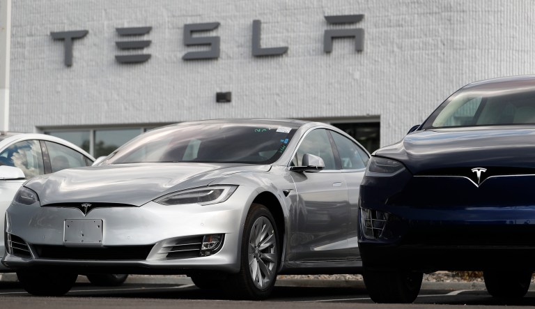 In this July 8, 2018, photo, 2018 Model 3 sedan sits next to a Model X on display outside a Tesla showroom in Littleton, Colo. Board members at Tesla are evaluating CEO and Chairman Elon Muskâs $72 billion proposal to take the electric car and solar panel maker private. Six of nine members say in a statement Wednesday, Aug. 8, that Musk began talking with the board about the move last week.