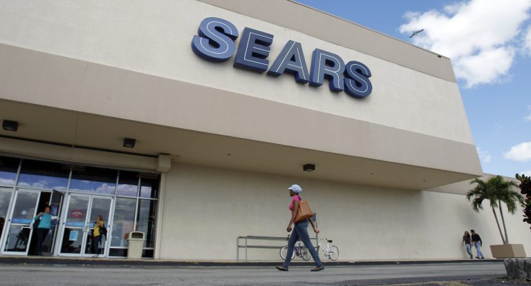 FILE - In this Friday, Nov. 9, 2012, file photo, a customer walks towards a Sears store in Hialeah, Fla. On Thursday, Aug. 21, 2014, Sears Holdings Corp. is scheduled to report quarterly financial results before the market opens. (AP Photo/Alan Diaz, File)