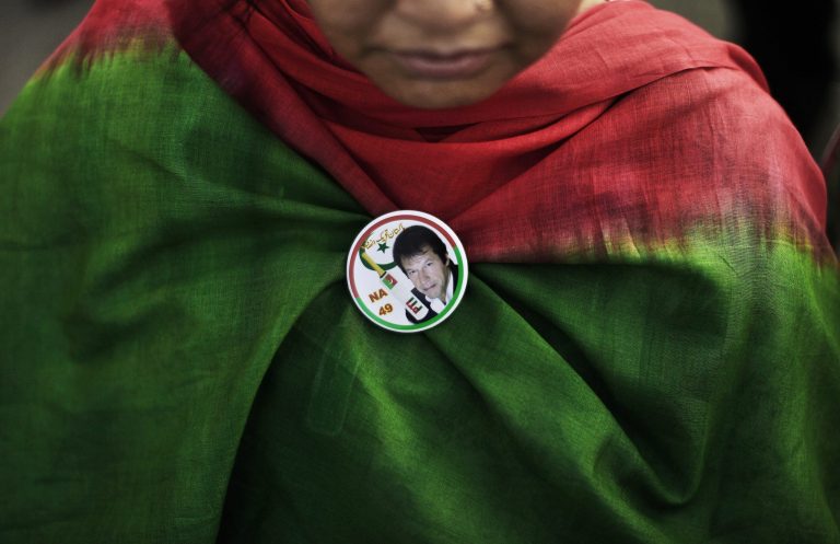 A Pakistani supporter of former cricket star-turned-politician, and leader of Pakistan Tehreek-e-Insaf party, Imran Khan, wearing a pin bearing Khan's image, takes part during a rally in Islamabad, Pakistan, Thursday, May 9, 2013. Pakistan is scheduled to hold parliamentary elections on May 11, the first transition between democratically elected governments in a country that has experienced three military coups and constant political instability since its creation in 1947. The parliament's ability to complete its five-year term has been hailed as a significant achievement. (AP Photo/Muhammed Muheisen)