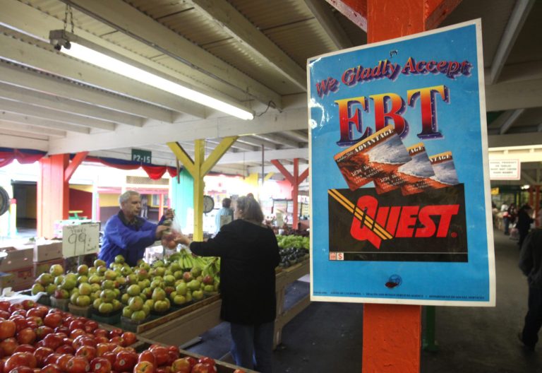   FILE - This Feb. 6, 2010 file photo shows a sign announcing the acceptance of electronic Benefit Transfer cards at a farmers market in Roseville, Calif. The House has voted to cut nearly $4 billion a year from food stamps, a 5 percent reduction to the nation's main feeding program used by more than 1 in 7 Americans.