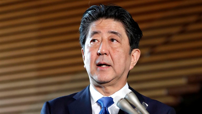 Japanese Prime Minister Shinzo Abe speaks to journalists following a strong earthquake, at his official residence in Tokyo.