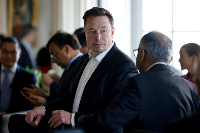 Twitter, now X. Corp, and Tesla CEO Elon Musk talks to another unidentified CEO prior to a meeting during the 6th edition of the 