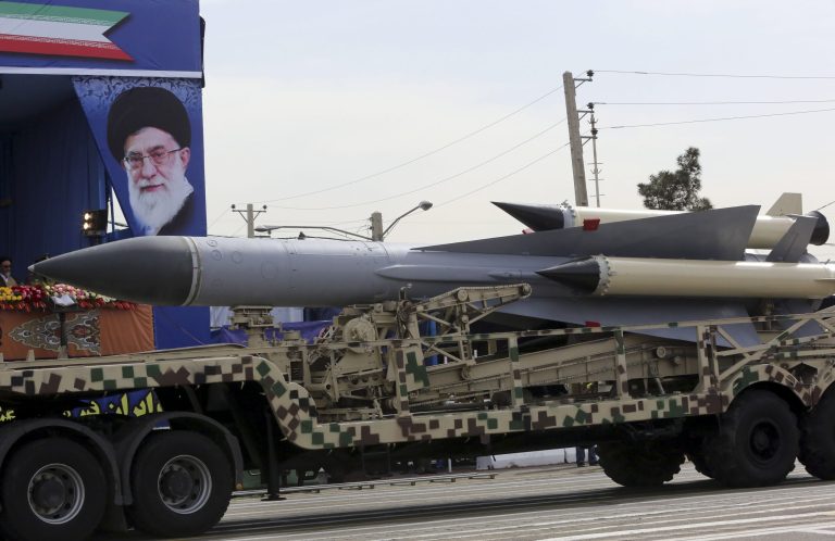 An Iranian missile passes in front of a portrait of the Iranian Supreme Leader Ayatollah Ali Khamenei during a military parade marking National Army Day outside Tehran, Iran, Friday, April 18, 2014. (AP Photo/Vahid Salemi)