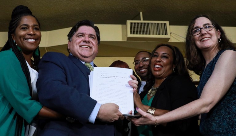Gov. J. B. Pritzker holds a bill that legalizes adult-use cannabis in the state of Illinois Tuesday, June 25, 2019 at Sankofa Cultural Arts and Business Center in Chicago. Illinois becomes the 11th to legalize the adult-use of recreational marijuana.