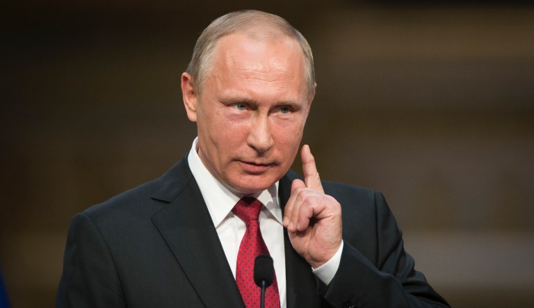 In this photo taken on Monday, May 29, 2017, Russian President Vladimir Putin gestures as he speaks during a shared news conference with French President Emmanuel Macron at the Palace of Versailles, near Paris, France. Putin says the allegations of Russian meddling in the U.S. presidential election are "fiction" invented by the Democrats in order to explain their loss.