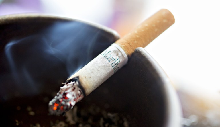 A Philip Morris Marlboro brand cigarette burns in an ashtray for this arranged photograph in Tiskilwa, Illinois, U.S., on Wednesday, July 12, 2017. Philip Morris International Inc. is scheduled to release earnings figures on July 20.
