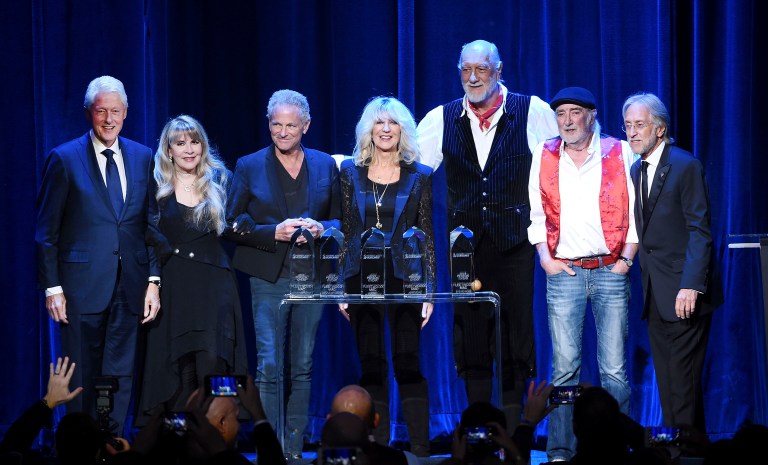 Former President Bill Clinton, left, and Recording Academy president and CEO Neil Portnow, right, pose with honorees, Stevie Nicks, from second left, Lindsey Buckingham, Christine McVie, Mick Fleetwood and John McVie onstage at the 2018 MusiCares Person of the Year tribute honoring Fleetwood Mac at Radio City Music Hall on Friday. (Photo by Evan Agostini/Invision/AP)
