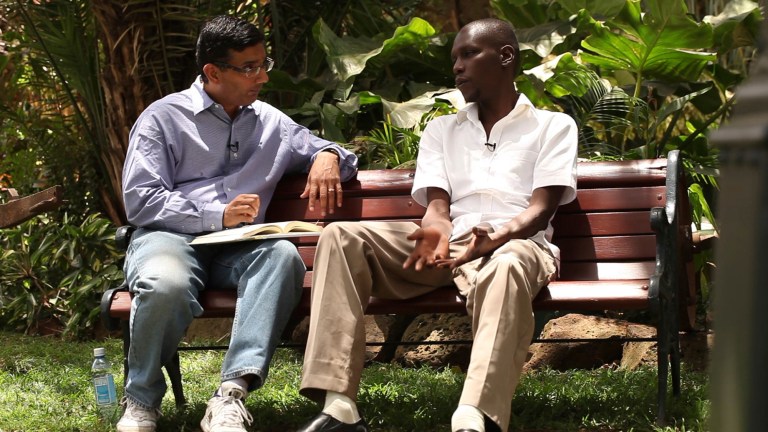 Conservative intellectual and film director Dinesh D'Souza interviews George Obama for a film. (AP Photo/Rocky Mountain Pictures, File)
