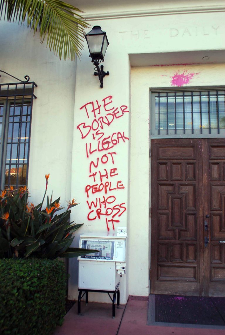 Graffiti and paint are splattered on the entrance to the Santa Barbara News-Press building Thursday, Jan. 8, 2015, in Santa Barbara, Calif. The newspaper has received criticism since running a story and photo about California allowing immigrants who entered the country illegally being allowed to apply for driver's licenses. Saturday's headline read: 