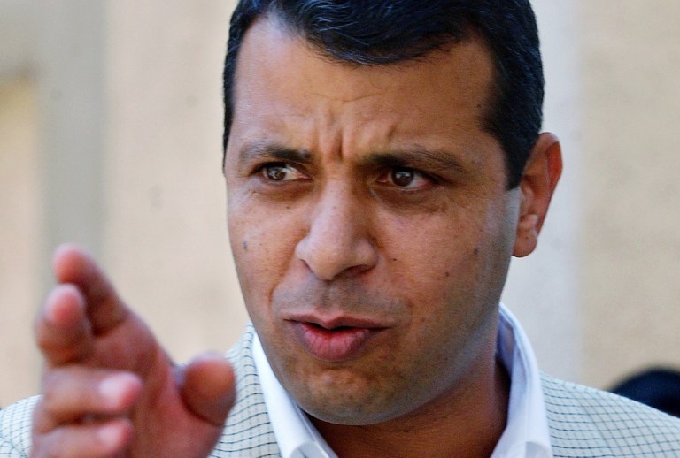 FILE - In this Aug. 23, 2004 file photo, former Palestinian security chief Mohammed Dahlan gestures prior to a meeting with leader Yasser Arafat at his compound in the West Bank town of Ramallah.A court has sentenced a leading rival of Palestinian President Mahmoud Abbas in absentia to two years in prison, effectively blocking him from a future leadership battle. The sentence against Mohammed Dahlan was handed down by a West Bank court in March, but was made public only Wednesday May 21, 2014 in the official Palestinian Authority newspaper. (AP Photo/Nasser Shiyoukhi, File)