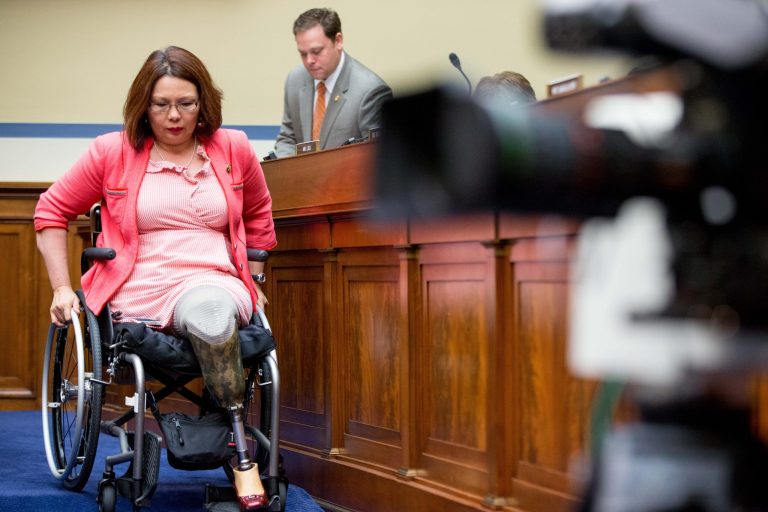 Rep. Tammy Duckworth, D-Ill., left, departs after speaking on Capitol Hill in Washington, Wednesday, June 17, 2015, during the House Oversight and Government Reform Committee hearing on the economic impact of regulating drone technology for personal and commercial uses as well as privacy concerns on the economic impact of regulating drone technology for personal and commercial uses as well as privacy concerns. (AP Photo/Andrew Harnik)