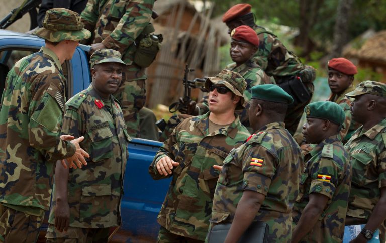   FILE - In this Sunday, April 29, 2012 file photo, U.S. Army special forces Master Sergeant Eric, center, who would only give his first name in accordance with special forces security guidelines, speaks with troops from the Central African Republic and Uganda, in Obo, Central African Republic, where U.S. special forces have paired up with local troops and Ugandan soldiers to seek out Joseph Kony's Lord's Resistance Army (LRA). Roughly one year after 100 U.S. special forces troops arrived in four Central Africa nations to advise African soldiers in their pursuit, Kony is still on the run and his exact whereabouts unknown. (AP Photo/Ben Curtis, File)  