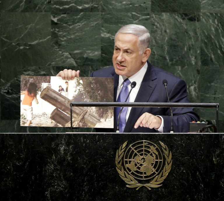 Benjamin Netanyahu, Prime Minister of Israel, holds up a picture of an alleged Hamas rocket launcher surrounded by children while speaking during the 69th session of the United Nations General Assembly at U.N. headquarters, Monday, Sept. 29, 2014. (AP Photo/Seth Wenig)