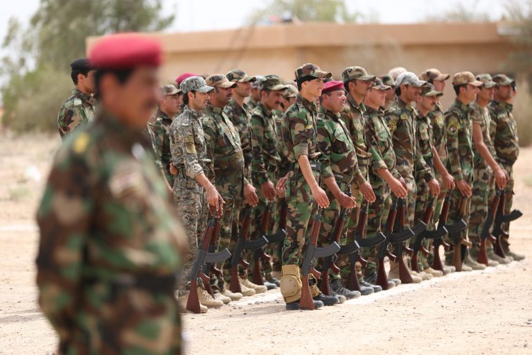 Sunni tribal volunteers stand in formation during their graduation ceremony in the town of Amiriyat al-Fallujah, west of Baghdad, Iraq, Friday, May 8, 2015. (AP Photo/Hadi Mizban)