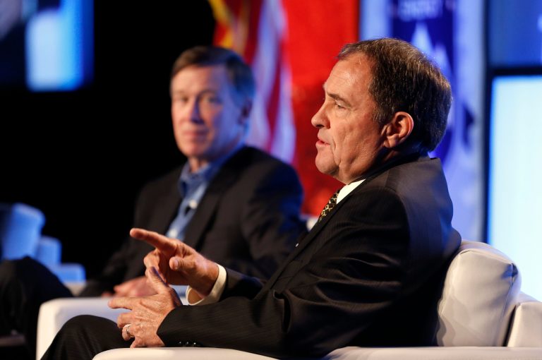 Utah Gov. Gary Herbert gestures, as Colo. Governor John Hickenlooper sits at left, during a forum session at the Rocky Mountain Energy Summit, in Denver, Wednesday Aug. 6, 2014. (AP Photo/Brennan Linsley)