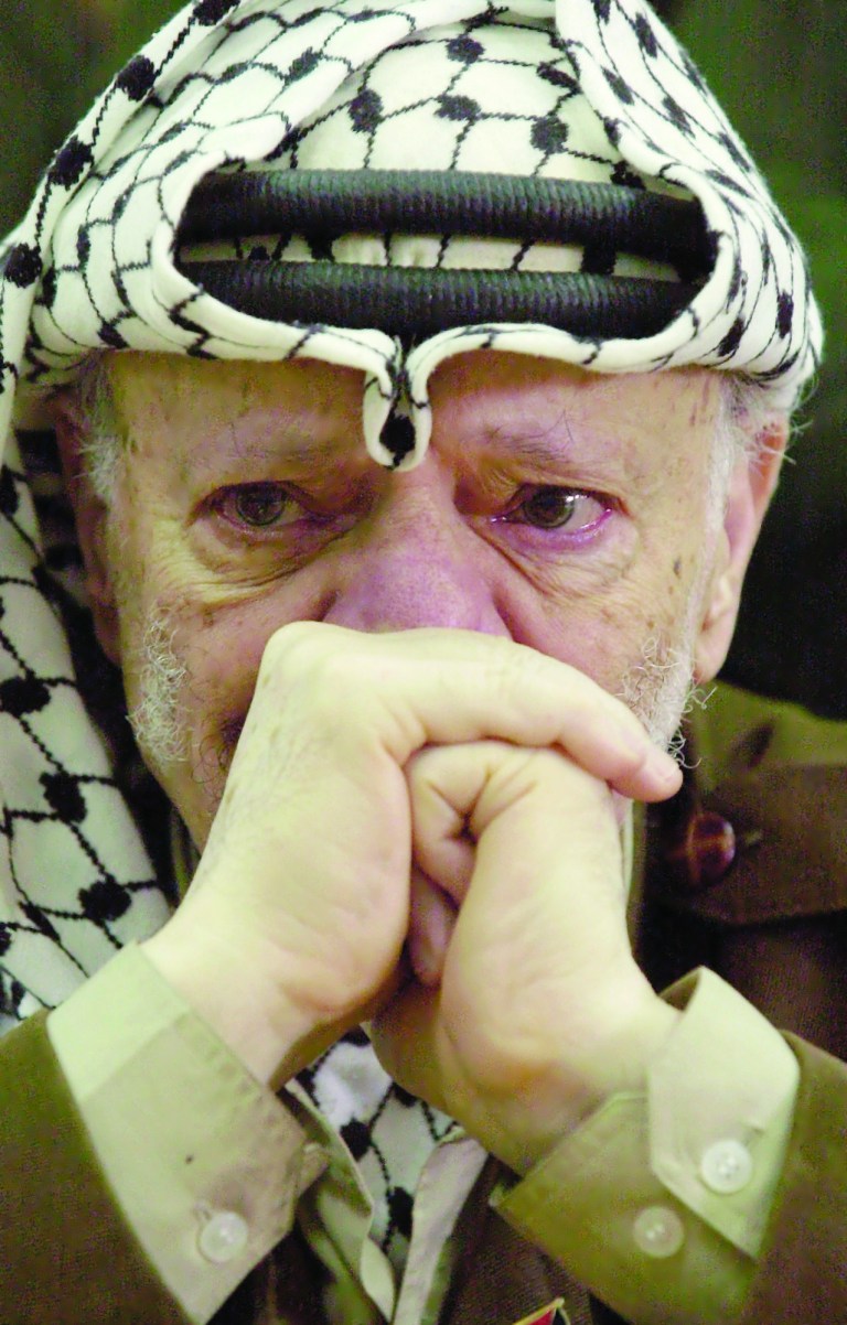 FILE - In this Aug. 13, 2003 file photo, Palestinian leader Yasser Arafat, with tears in his eyes, after he was informed of the death of his sister Yousra Abdel Raouf Al Kidwah at his compound in the West Bank town of Ramallah. French prosecutors opened a murder inquiry into the death of Yasser Arafat on Tuesday, Aug. 28, 2012, judicial officials told a French new agency, after his widow and a TV investigation raised new questions about whether the Palestinian leader was poisoned. (AP Photo/Nasser Nasser, File)