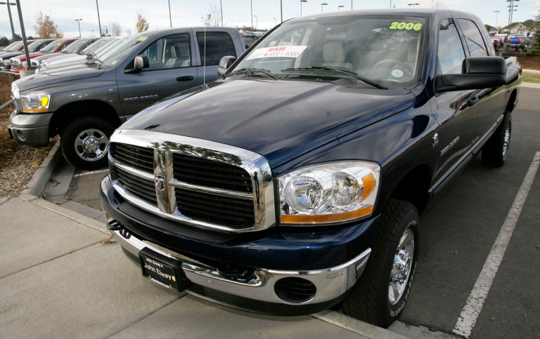 FILE - This Nov. 5, 2006 file photo shows 2006 Ram 3500 SLT Mega Cab four-wheel-drive pickup trucks on the back lot of a Dodge dealership in the southeast Denver suburb of Centennial, Colo. U.S. safety regulators are investigating older-model Ram pickup trucks with manual transmissions because the engines can be started without the clutch being depressed. The probe covers about 110,000 Ram 2500 and 3500 pickups made by Chrysler from the 2004 through 2006 model years. (AP Photo/David Zalubowski, File)