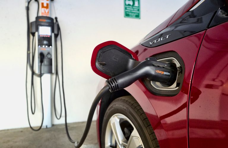 A Chevrolet Volt hybrid car charges its battery at a ChargePoint station at a parking garage in Los Angeles.