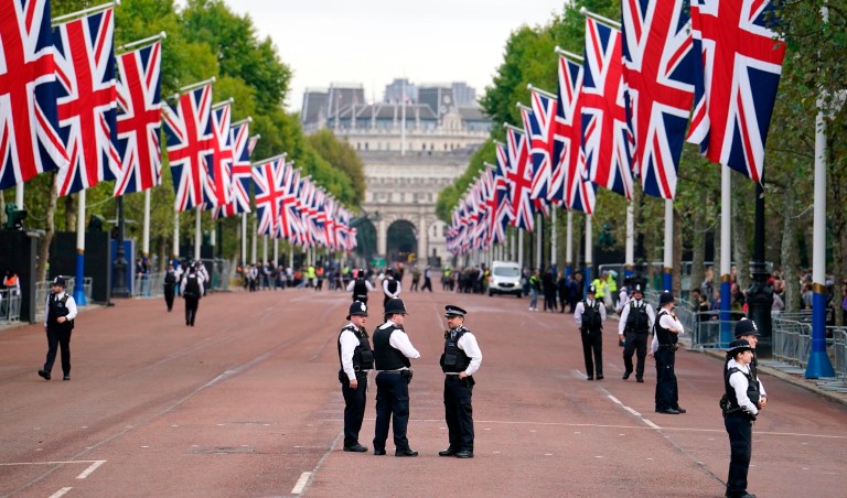 Police officers stand guard on The Mall ahead of the ceremonial procession of the coffin of Queen Elizabeth II from Buckingham Palace to Westminster Hall in London on Sept. 14, 2022. The queen will lie in state in Westminster Hall for four full days before her funeral on Sept. 19. 