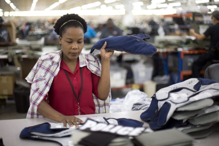 In this Sept. 19, 2014 photo, Laurette Eugene makes the final assembly of body armor at the Point Blank Body Armor factory in Pompano Beach, Fla. The government issues its third and final estimate of how fast the U.S. economy grew in the April-June quarter on Friday, Sept. 26, 2014. (AP Photo/J Pat Carter)