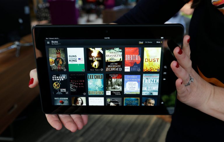 FILE - In this Sept. 24, 2013 file photo, the 8.9-inch Amazon Kindle HDX tablet computer is held up for a photo in Seattle. Amazon is rolling out a new subscription service that will allow unlimited access to thousands of electronic books and audiobooks for $9.99 a month in the online giant's latest effort to attract more users. (AP Photo/Ted S. Warren, File)