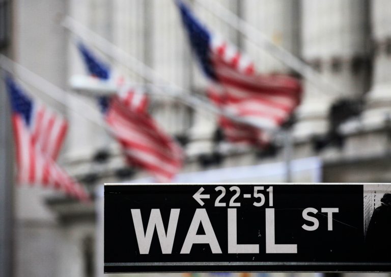 FILE - This April 22, 2010, file photo, shows a Wall Street sign in front of the New York Stock Exchange. Global stock markets were subdued on Tuesday, Sept. 9, 2014, but the dollar hit a six-year high against the yen on investor expectations the Federal Reserve will end stimulus and raise interest rates in coming months. (AP Photo/Mark Lennihan, File)