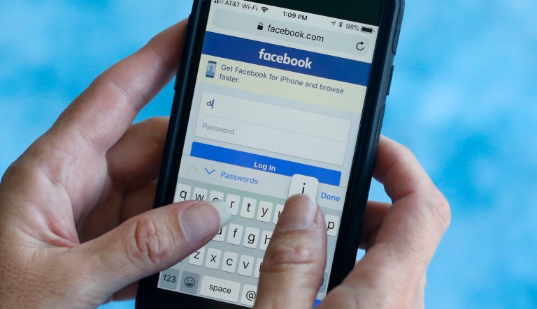 In this Tuesday, Aug. 21, 2018, photo a Facebook start page is shown on a smartphone in Surfside, Fla.