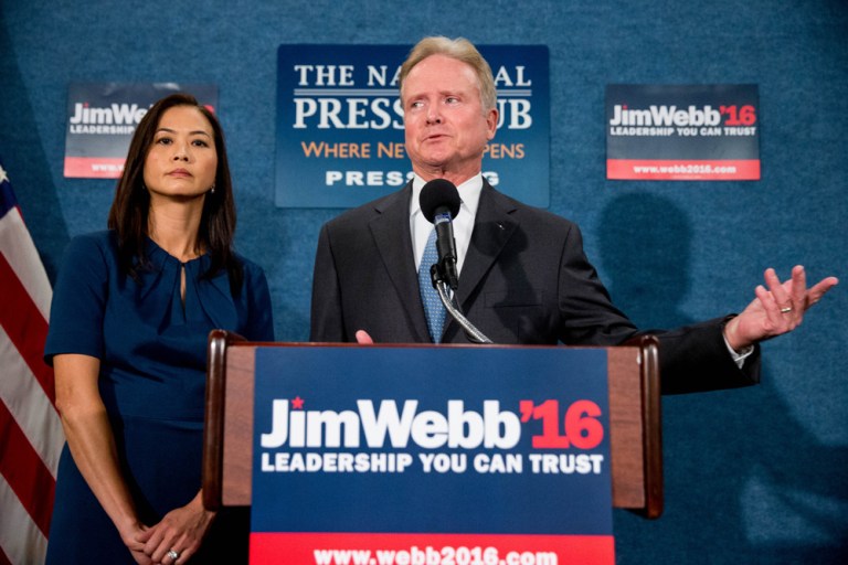 Former Virginia Sen. Jim Webb, accompanied by his wife Hong Le Webb, left, announces he will drop out of the Democratic race for president, Tuesday, Oct. 20, 2015, during a news conference at the National Press Club in Washington. (AP Photo/Andrew Harnik)
