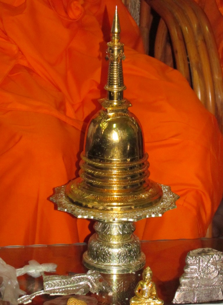 This Thursday, Feb. 6, 2014 photo, shows a golden urn after being recovered in Takeo province, south of Phnom Penh, Cambodia. Police in Cambodia said Friday, Feb. 7, 2014 they have recovered the precious golden urn stolen last year that contains what are considered to be remnants of Buddha's body. The urn was taken from a mountain shrine 40 kilometers (25 miles) outside the capital in mid-December. National Police spokesman Kirt Chantharith said it was recovered Thursday from a house in the southern province of Takeo, and one man was arrested in connection with the theft. (AP Photo)
