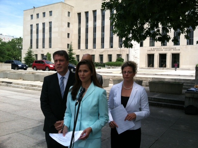 A lawsuit challenging constitutionality of the U.S. Consumer Finance Protection Board was filed July 22, 2013 in federal court.  Standing in front of the U.S. District Courthouse in Washington, D.C. are, left to right, attorney Randall K. Miller representing plaintiff Morgan Drexen, Inc, spokesperson Karen Carlson and plaintiff Kimberly A. Pisinski. (Photo by Richard Pollock)