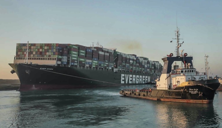 In this photo released by Suez Canal Authority, the Ever Given, a Panama-flagged cargo ship, is pulled by one of the Suez Canal tugboats, in the Suez Canal, Egypt, Monday, March 29, 2021. Engineers on Monday "partially refloated " the colossal container ship that continues to block traffic through the Suez Canal, authorities said, without providing further details about when the vessel would be set free. 