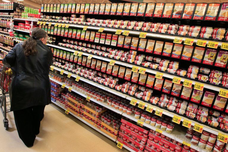 FILE - This Feb. 7, 2012 file photo shows a shopper walking down the canned soup aisle at a grocery store in Cincinnati. Food companies and restaurants could soon face government pressure to make their foods less salty _ a long-awaited federal effort to try and prevent thousands of deaths each year from heart disease and stroke.  (AP Photo/Al Behrman, File)