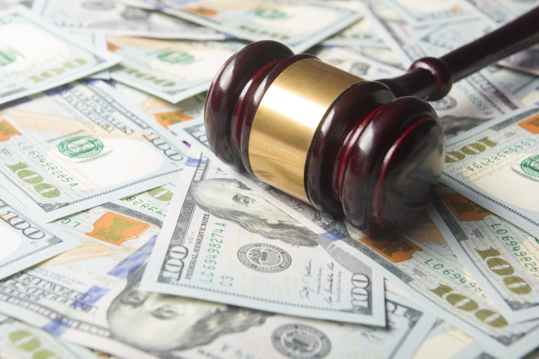 Judges Or Auctioneer Gavel On The Dollar Cash Background.