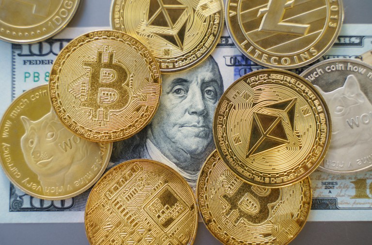 Bitcoins over a $100 bill.
