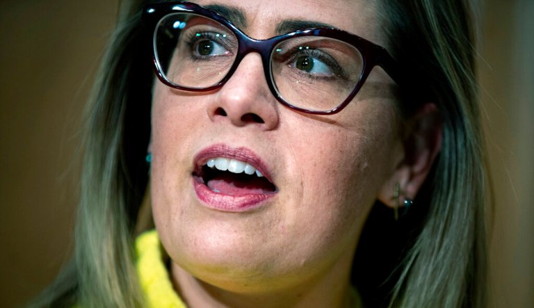Rep. Kyrsten Sinema, D-Ariz., talks to campaign volunteers at a Democratic campaign office on primary election day Tuesday, Aug. 28, 2018, in Phoenix.