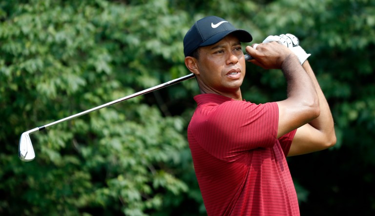 Tiger Woods watches his tee shot on the ninth hole during the final round of the PGA Championship golf tournament at Bellerive Country Club, Sunday, Aug. 12, 2018, in St. Louis.